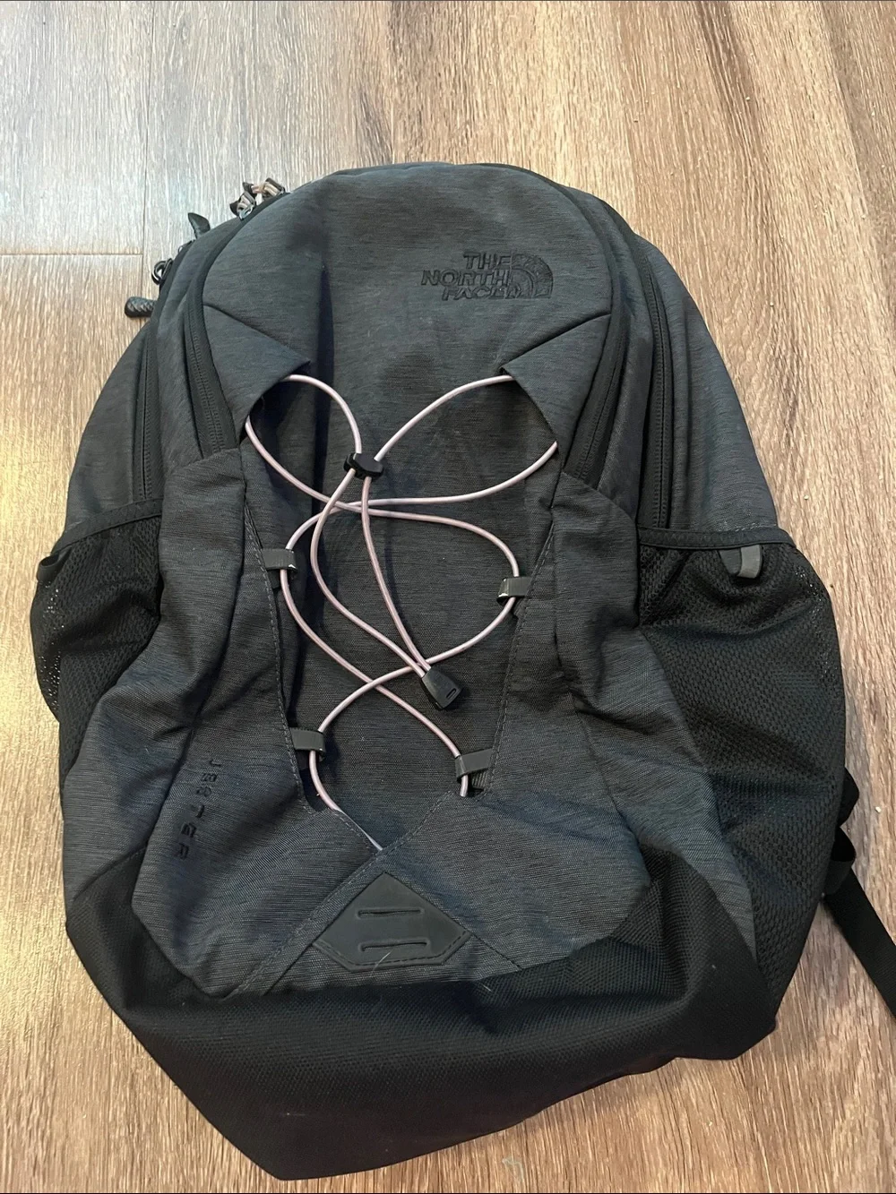 The NorthFace Jester Black Backpack with Light Pink Bungee Cord
